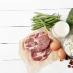 Healthy food rich in proteins on a white wooden table.