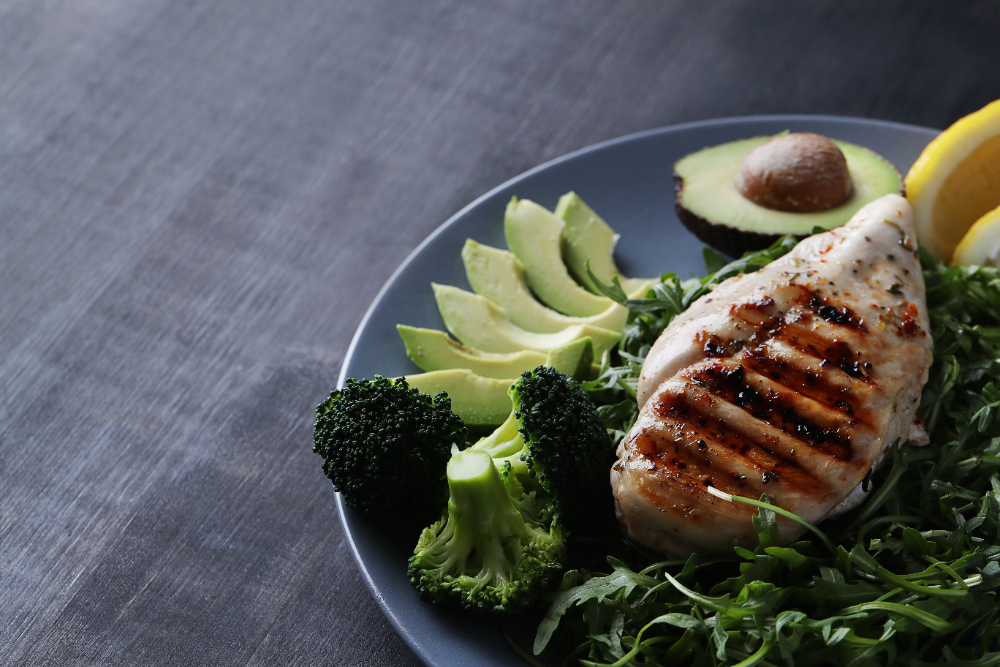 Healthy protein dish with chicken, avocado and broccoli.