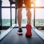 Male legs on a treadmill.