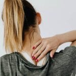 Woman with muscle soreness after workout