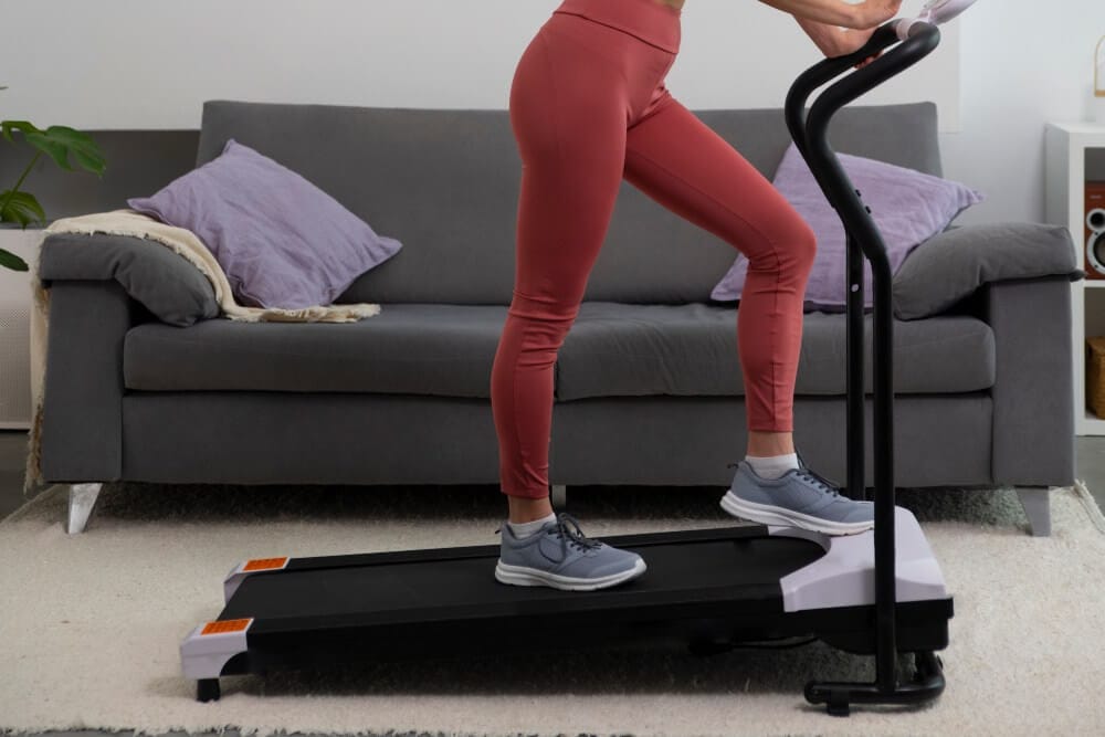 Woman on a treadmill at home, incline walking.