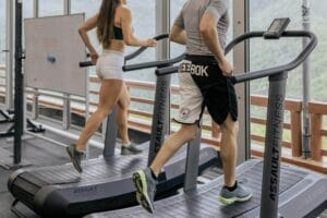 Man and woman incline walking on a treadmill