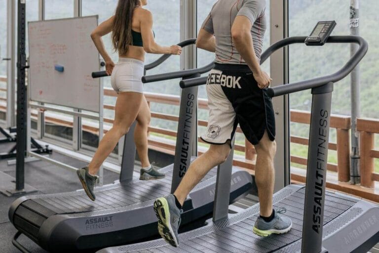 Man and woman incline walking on a treadmill